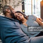 Married couple embracing on sofa